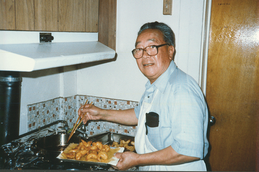 Elderly man cooking and looking at camera
