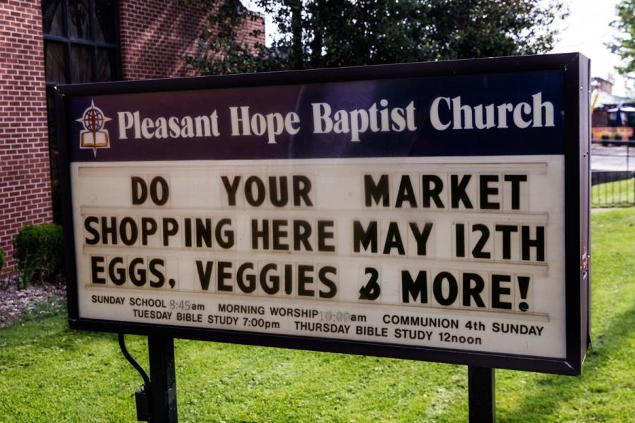 a church sign advertising fresh produce in baltimore