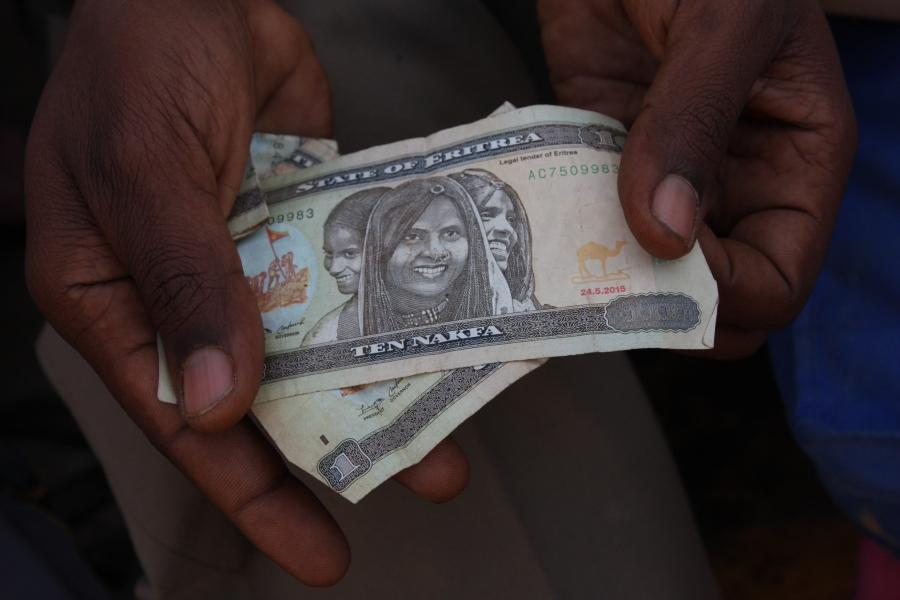 small wad of money from an eritrean man at the border