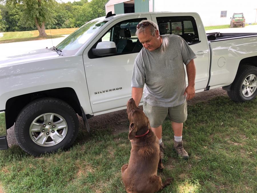 Farmer Dale Hadden and his dog Boomer. Hadden worries that if commodity prices stay depressed into next year, there will be an exodus of people farming in Illinois