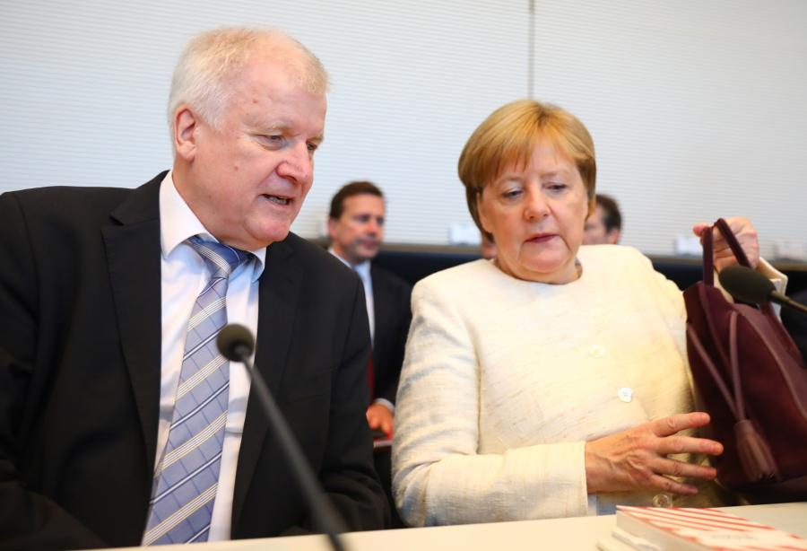 German Chancellor Angela Merkel and Interior Minister Horst Seehofer, who is also the leader of the Christian Social Union in Bavaria, meet in Berlin, Germany, July 3, 2018. The coalition partners reached a deal on tightening border procedures to limit mi