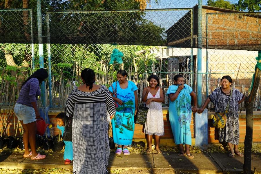 6 women stand in a garden 