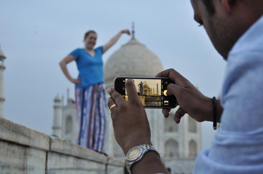 a picture of someone taking a picture of the Taj Mahal 