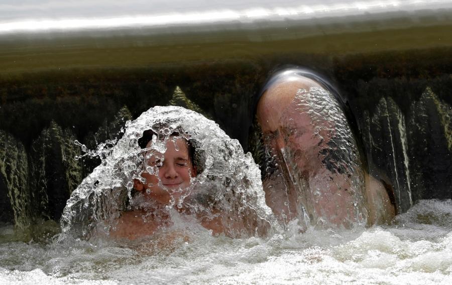People cool off at in the Berounka river near Prague, Czech Republic, July 22, 2018.