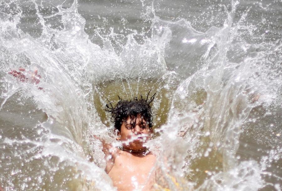 A boy jumps into the water in Cairo, Egypt.