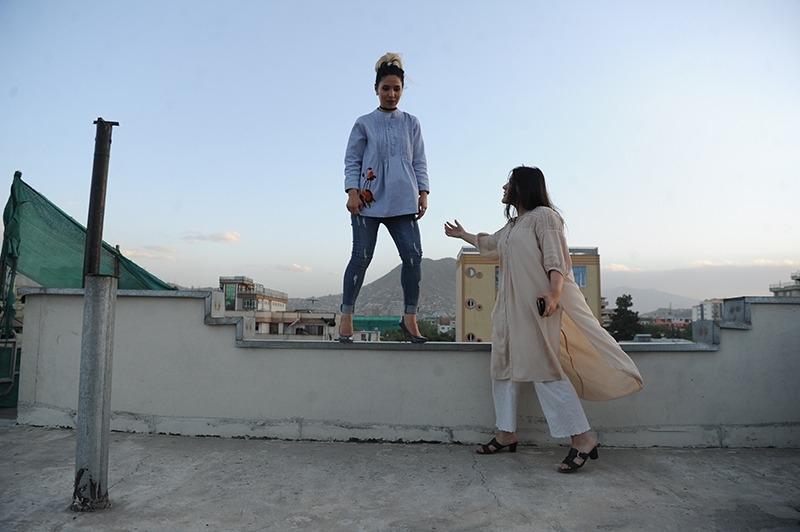 Fashion designer Rahiba Rahimi directs her model, Marzie Noori in Kabul, Afghanistan.