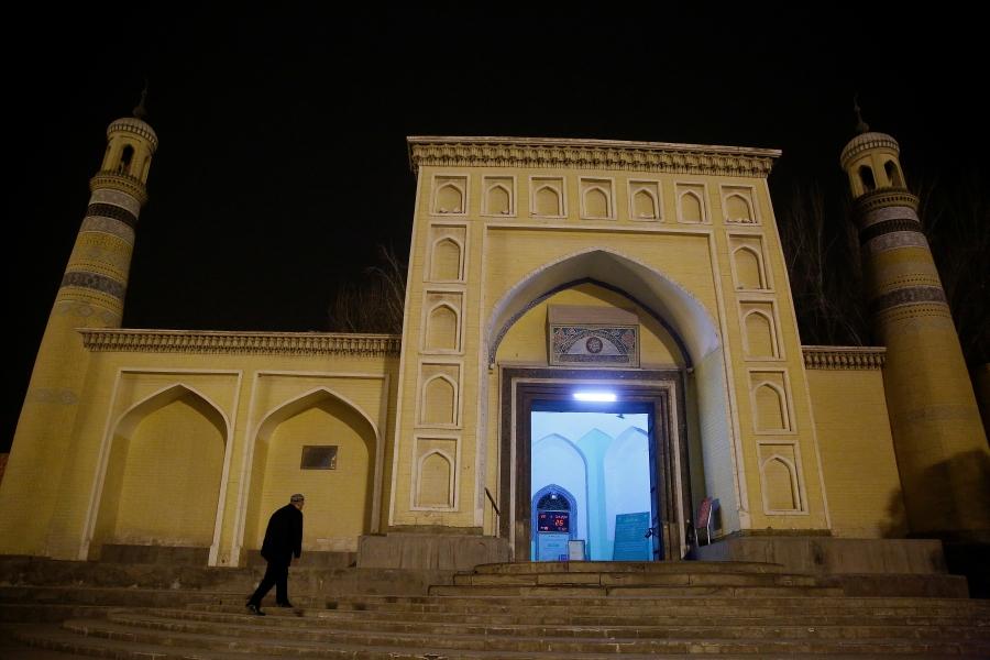 A man arrives at the Id Kah Mosque for morning prayers in Kashgar.