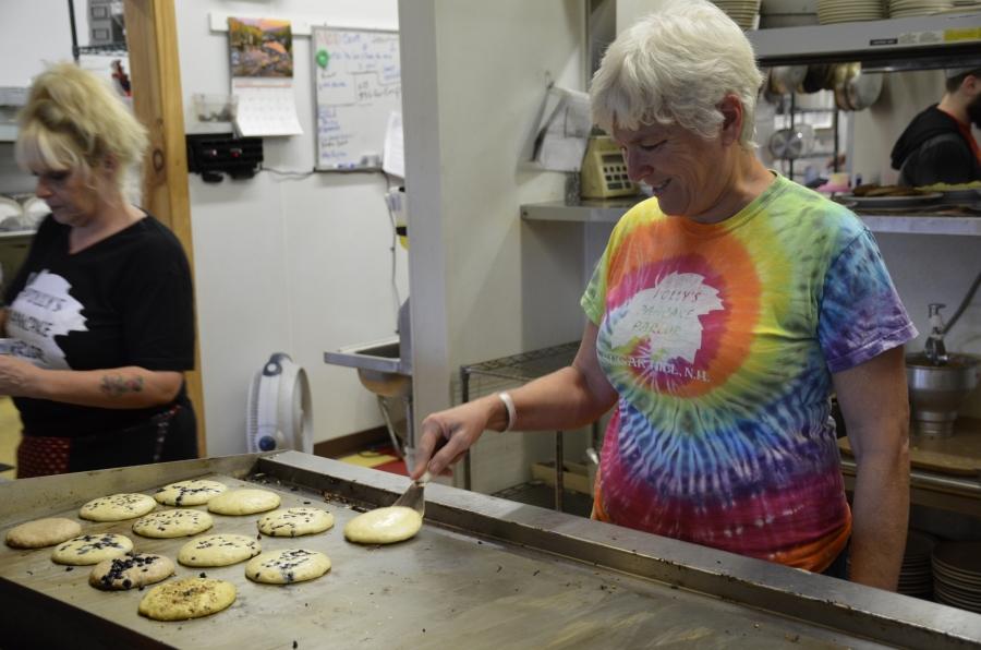 Kathie Aldrich Côté, owner of Polly’s Pancake Parlor, grills up pancakes prepared from homemade batter recipes. 