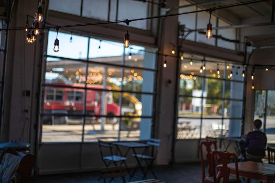 The view inside Refuge Coffee Co.’s cafe with the cafe's string lights in focus.