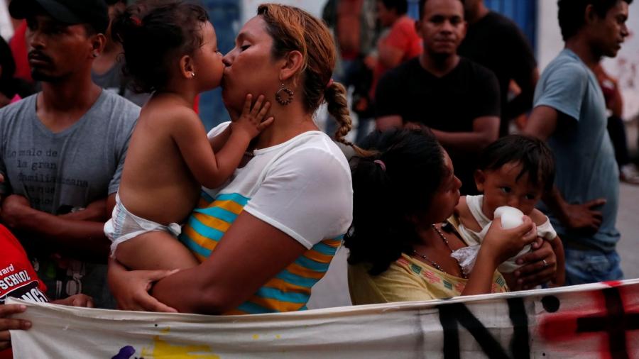 A mother receives a kiss from her toddler. 