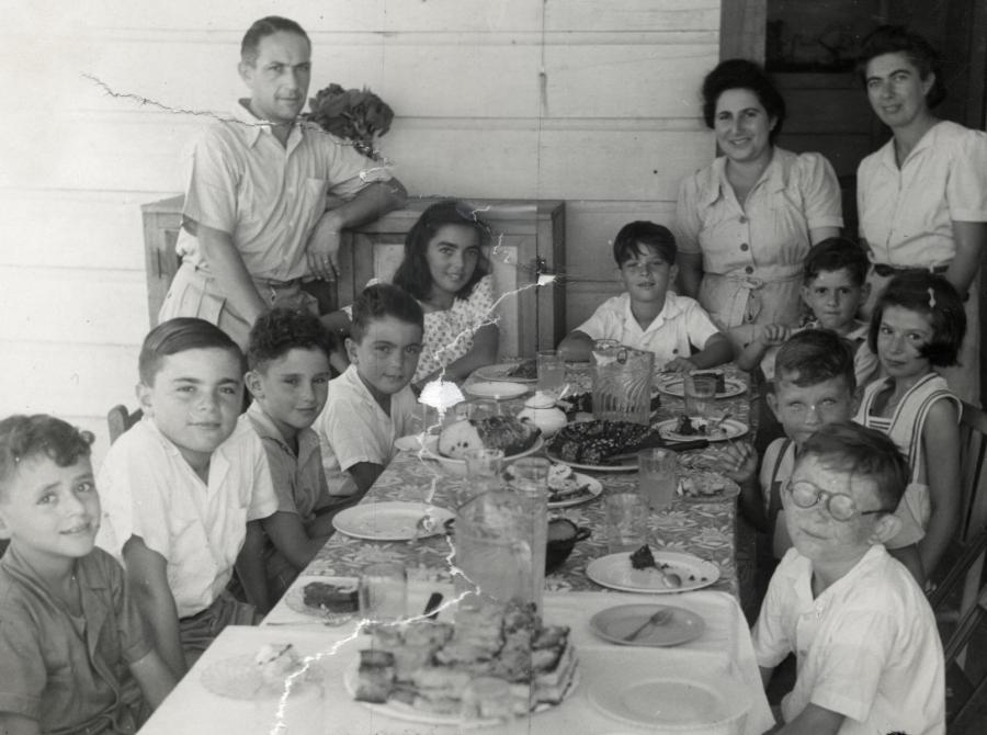 School children sit down for a meal in the Sosúa refugee colony. 