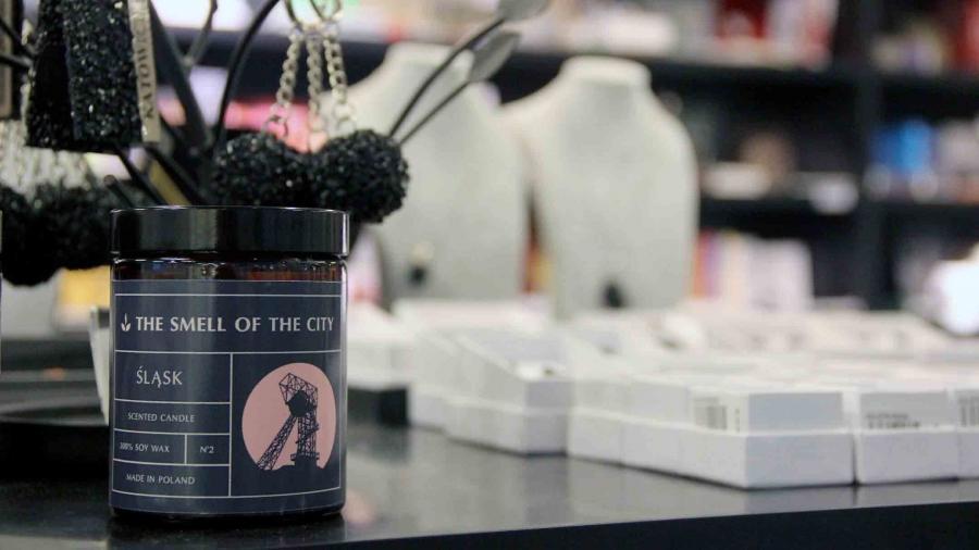 A candle labeled "smell of the city" sits on a counter