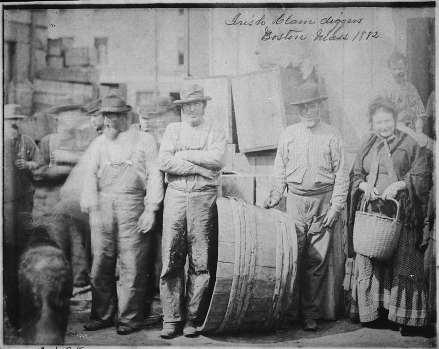 Bearded Irish clam diggers and a matronly companion. A black and white photo from 1882.