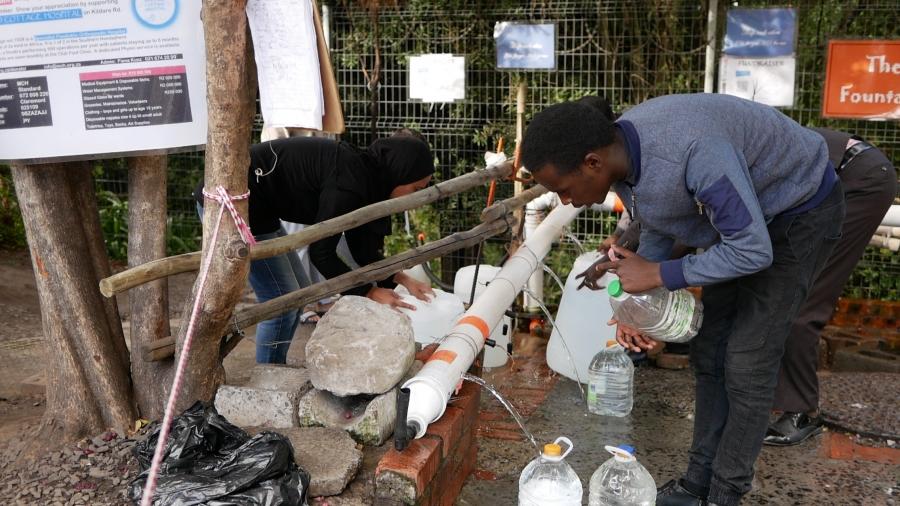 Cape Town residents gather to collect water at a spring with makshift spigots ear Table Mountain. It's one of dozens of open springs across the city where residents come to collect extra water to add to their meager daily quota of 13 gallons.