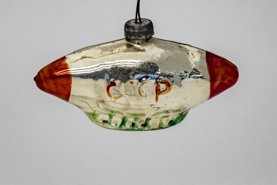 A red and gold Soviet-style blimb ornament made of tin. 