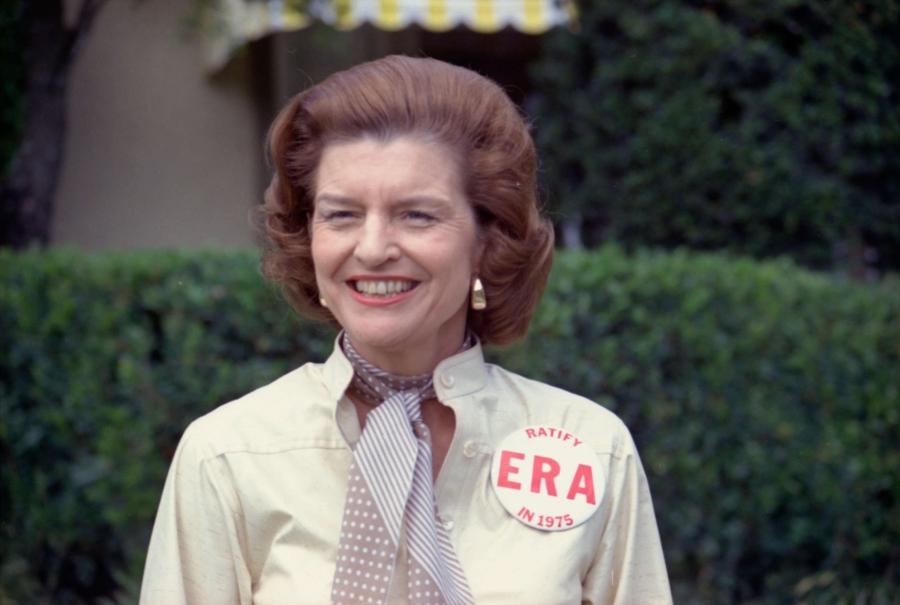 Former first Lady Betty Ford wears a large button "EPA" button