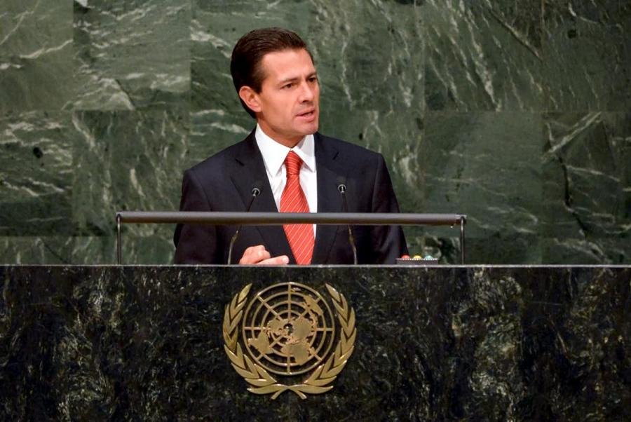 Former Mexican President Enrique Peña Nieto delivers a speech at a podium 