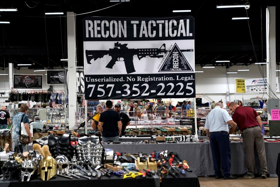 A sign for Recon Tactical is displayed at the Guntoberfest gun show 