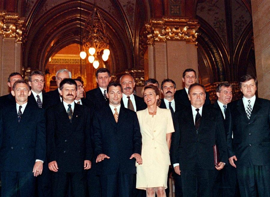Government officials pose around Viktor Orbán in a group photo. There is only one woman in the group.