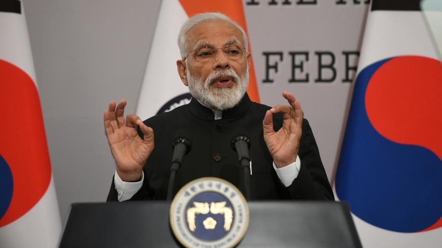 India’s Narendra Modi gestures behind a podium 