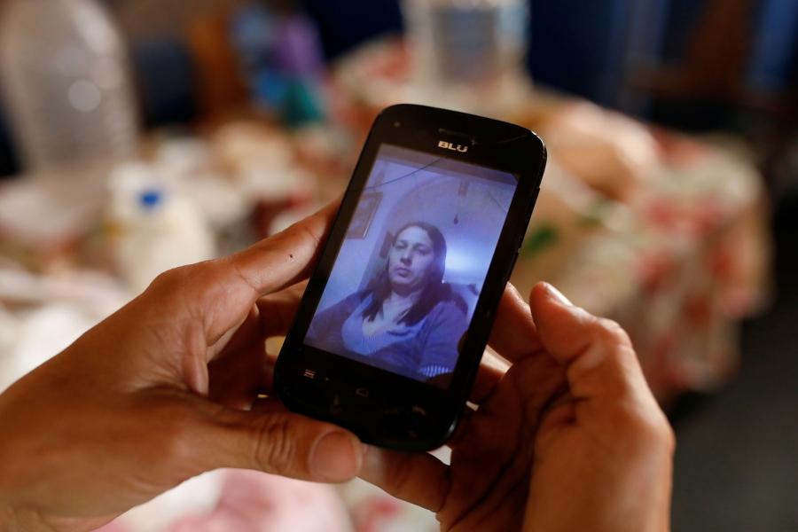 In a close-up photograph of a cell phone with a picture of Yaneidi Guzman on screen.