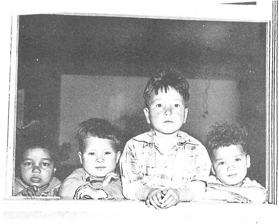 A black and white image of four young children