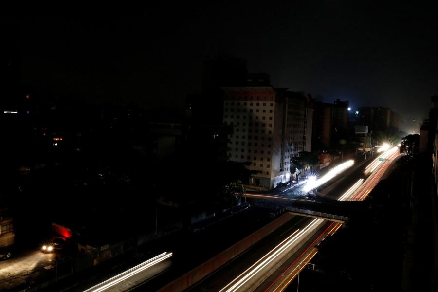 The lights from cars blur into long yellow and red lines down one of the main roads of Caracas during the blackout.