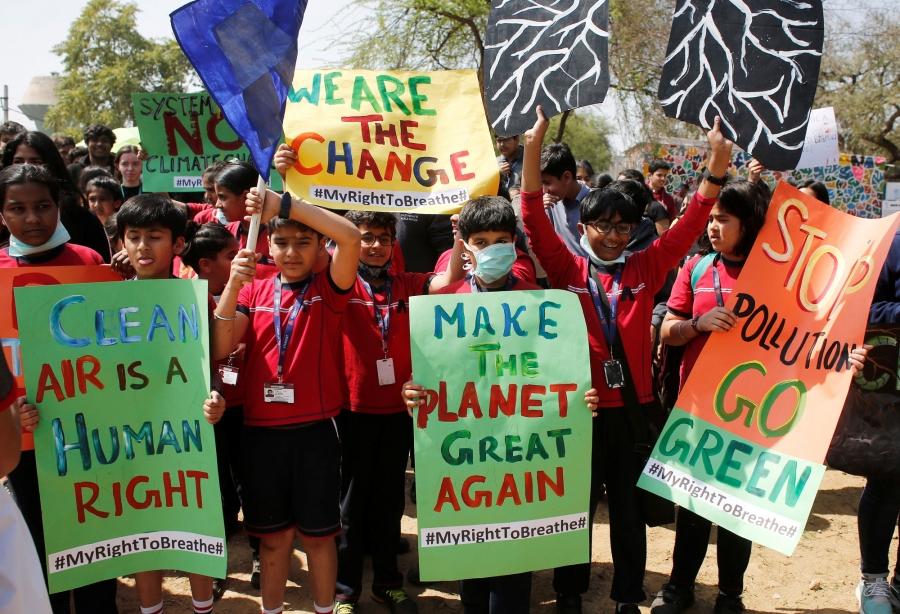 Students in India are shown protesting and carrying a sign that reads: "Make the planet green again."