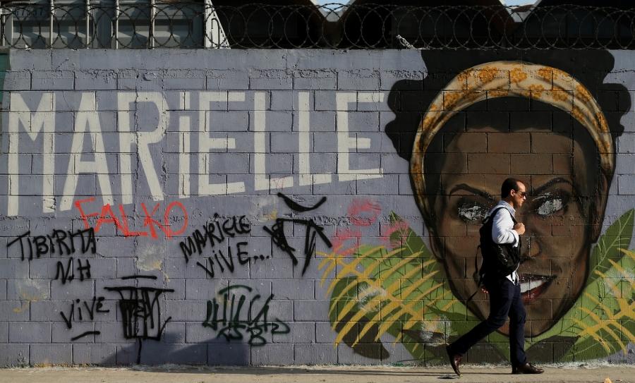 Mural of Marielle Franco's face against grey background. 