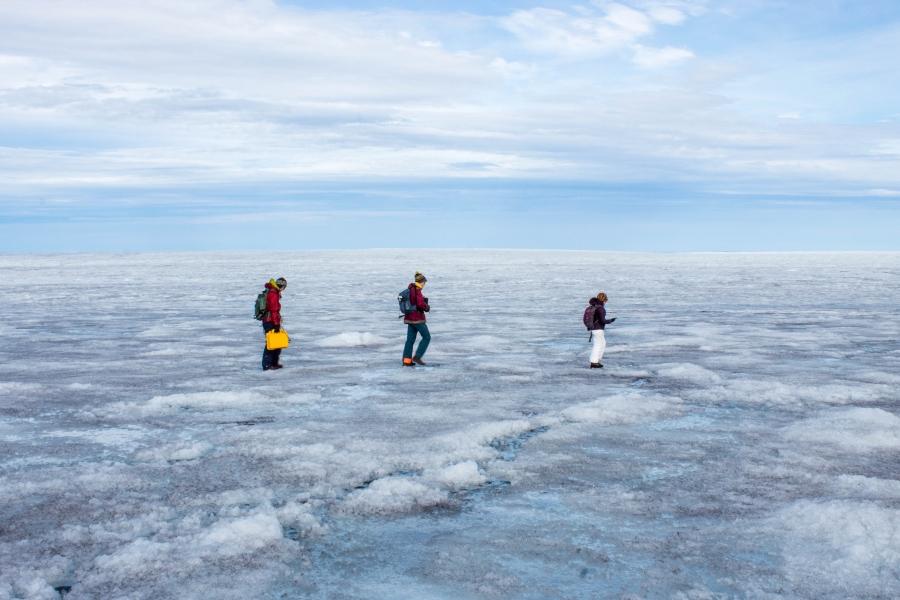 Students Rosie Leone, Aidan Stansberry and Ian MacDowell  are shown bundled in artic-ready clothing and walking across the ice.