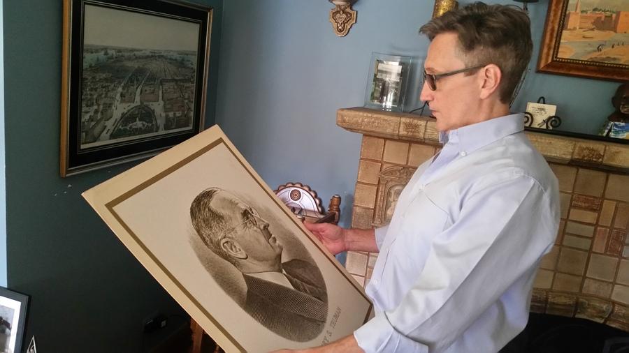 Clifton Daniel holds a picture of President Truman