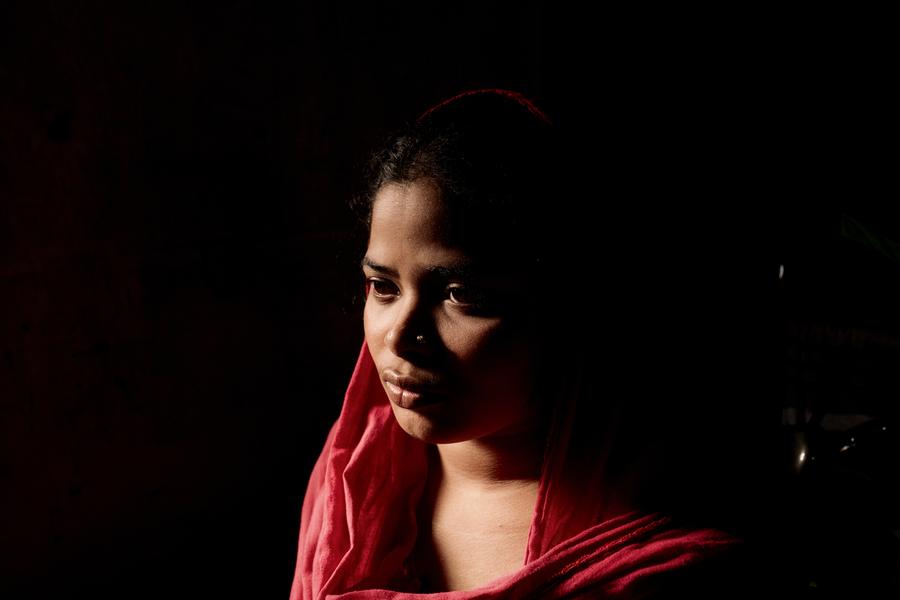 Close up of a young woman wearing a red shawl.