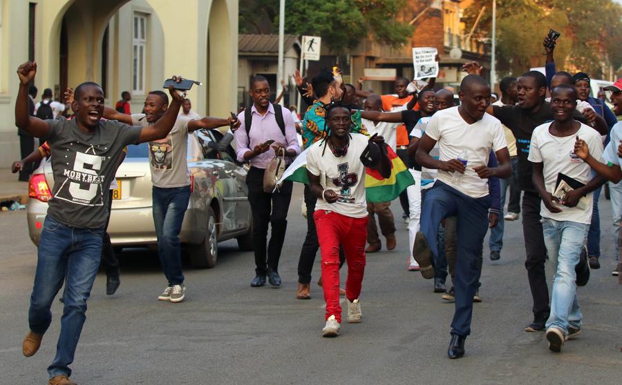 Zimbabweans celebrate after President Robert Mugabe resigns in Harare, Zimbabwe, Nov. 21, 2017.
