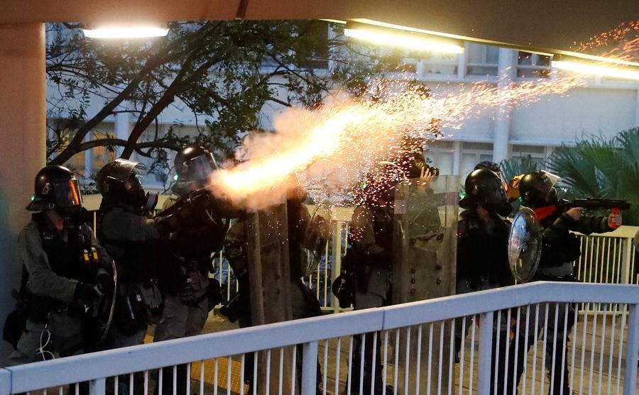 Police officers fire tear gas at demonstrators during a protest in Hong Kong