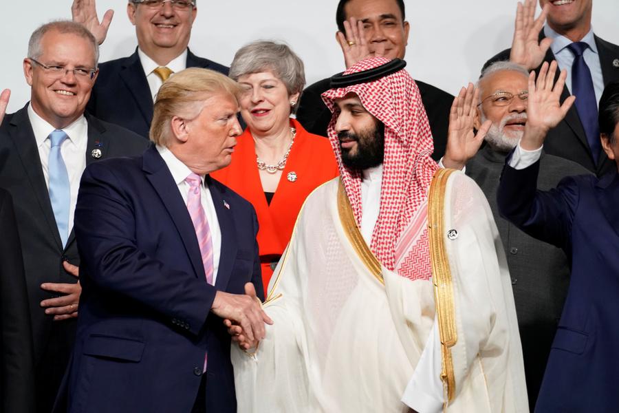 US President Donald Trump shakes hands with Saudi Arabia's Crown Prince Mohammed bin Salman during family photo session with other leaders and attendees at the G20 leaders summit