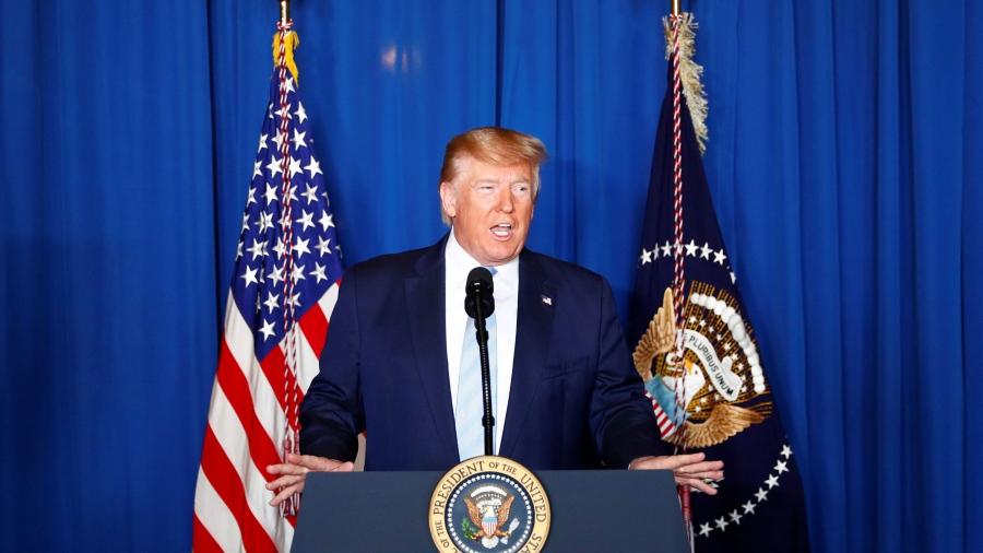 Trump stands behind a podium
