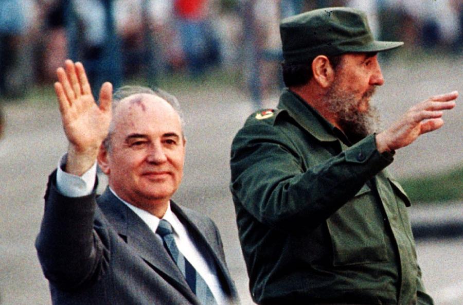 Soviet leader Mikhail Gorbachev (L) and Cuban leader Fidel Castro wave from an open top car as it drives through Havana's Revolution Square in this April 2, 1989 file photo.