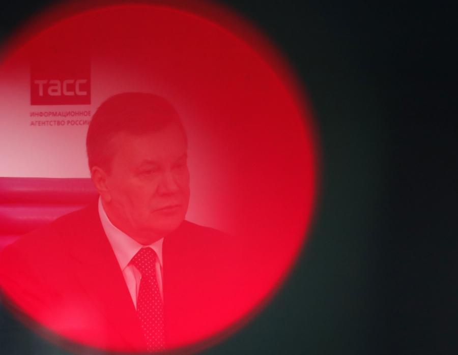 A man seen through a red circle of light