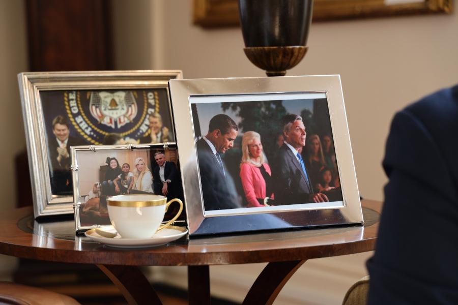 A side table with photos, including one with President Barack Obama