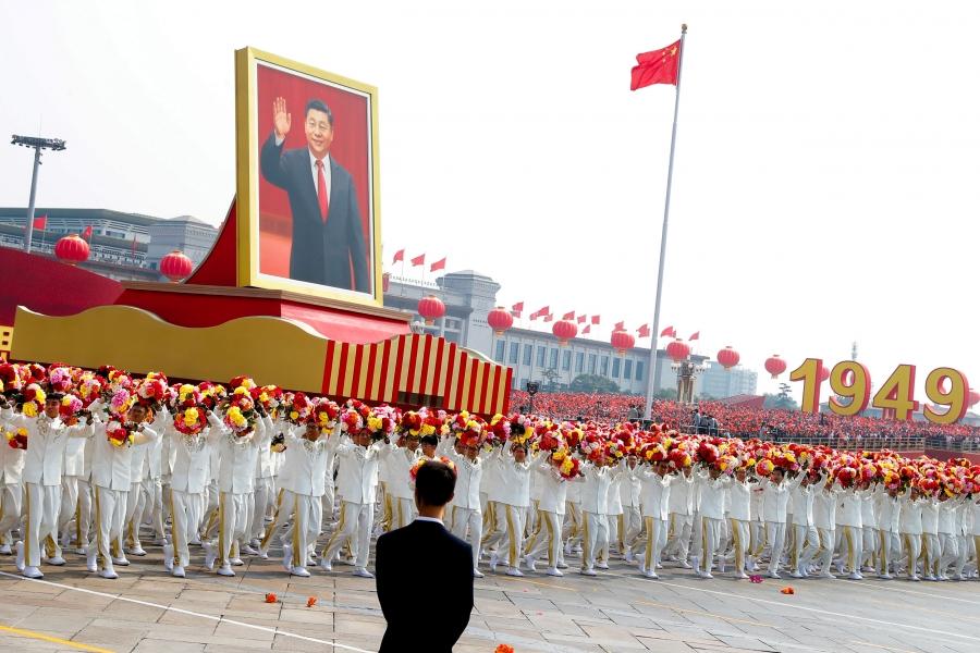 A float carrying a portrait of Chinese President Xi Jinping moves through Tiananmen Square