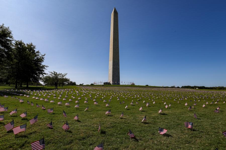 The Washington Monument surrounded by small flags in the ground around it, in memory of people who died from the coronavirus pandemic. 