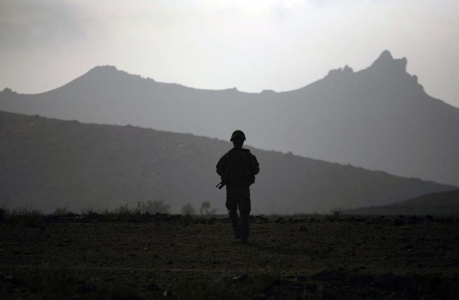 Silhouette of soldier with mountains in the background