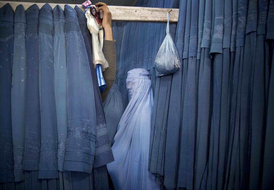 An Afghan woman waits in a changing room to try out a new Burqa, in a shop in the old city of Kabul, Afghanistan, on April 11, 2013. Before the Taliban took power in Afghanistan, the Burqa was infrequently worn in cities. While they were in power, the Tal
