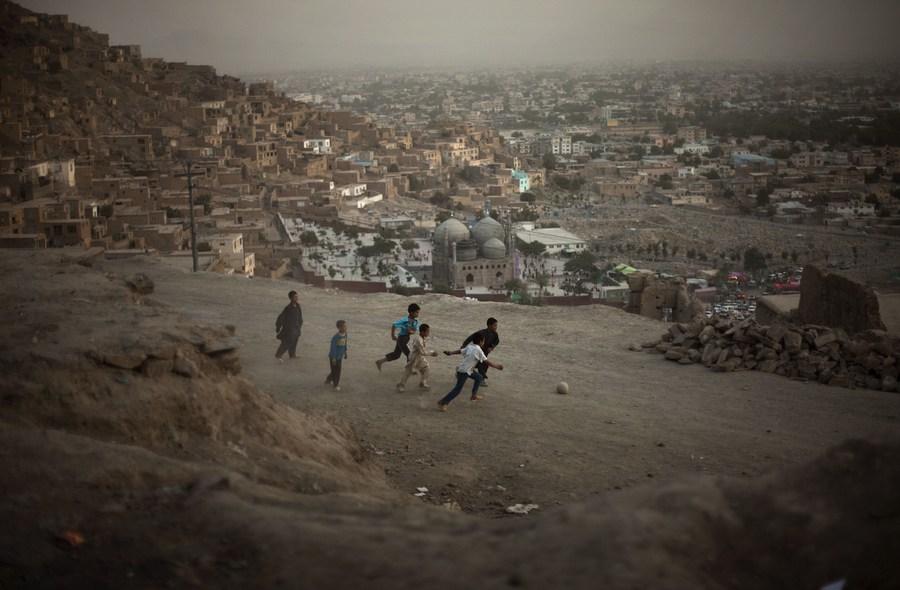 Afghan children play football in a street in Kabul, Afghanistan, on July 17, 2009. 
