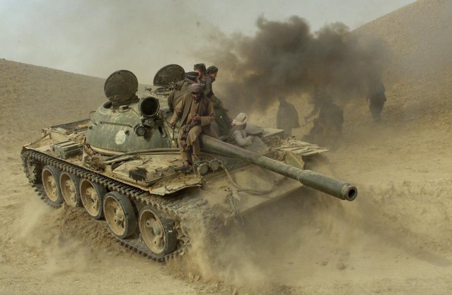 Defecting Taliban fighters maneuver a tank through the front line near the village of Amirabad, between Kunduz and Taloqan, on Nov. 24, 2001. 