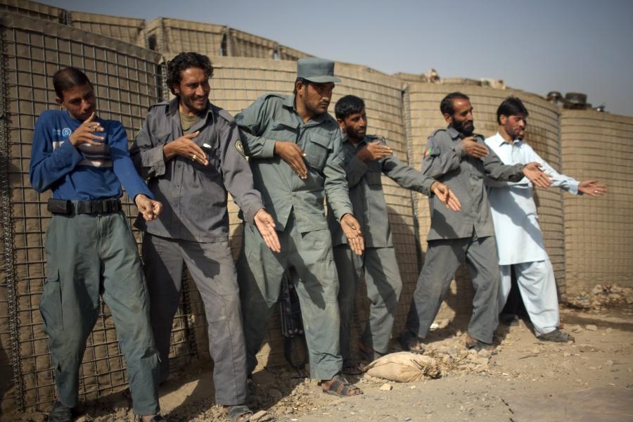 Afghan policemen simulate weapons orientation during a training session with U.S. soldiers from 2nd PLT Diablos 552nd Military Police Company, on the outskirts of Kandahar City, Afghanistan, on Oct. 26, 2010. 