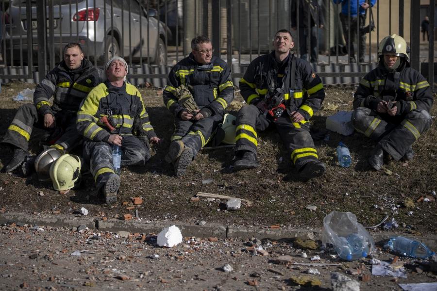Ukrainian firefighters after extinguishing an apartment building blaze damaged by a rocket attack in Kyiv.