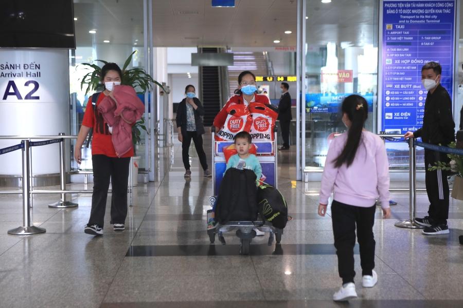 Vietnamese nationals arrive at the Hanoi airport after fleeing Ukraine on March 8, 2022. 