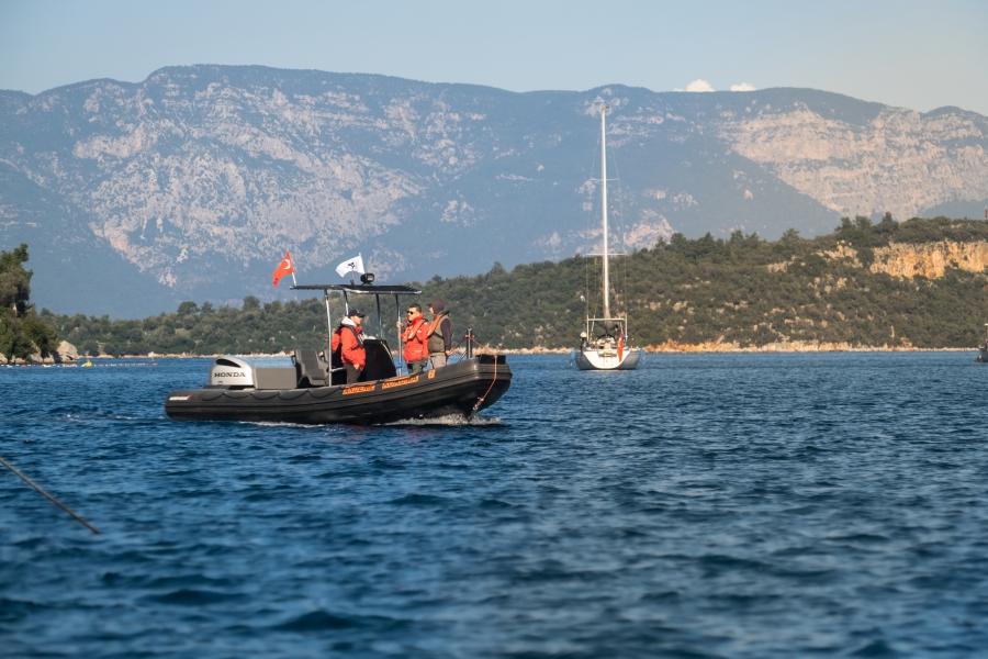 Zafer Kizilkaya and team on a small motorized boat in the sea on patrol