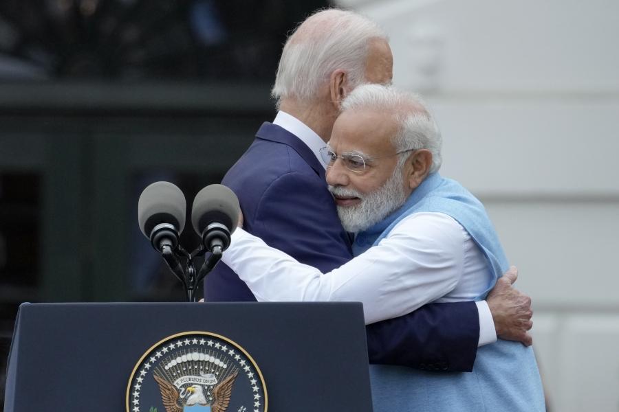Biden and Modi hugging each other on stage